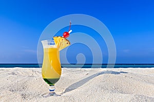 Fruity cocktail is on a beach