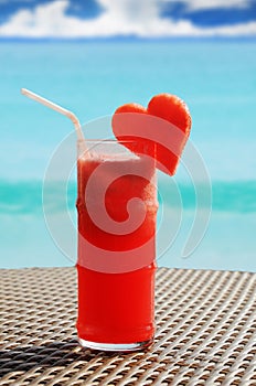 Fruity cocktail on a beach table