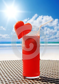 Fruity cocktail on a beach table