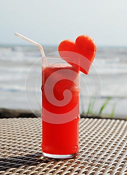 Fruity cocktail on a beach table