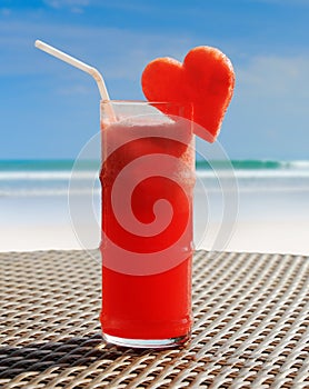 Fruity cocktail on a beach table