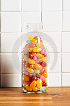Fruity jellybeans. Tasty colorful jelly beans in glass bottle