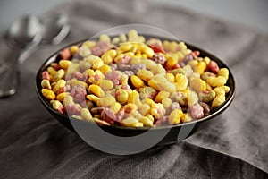 Fruity Kids Breakfast Cereal with Milk in a Bowl, side view