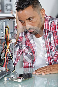 frustated man next to broken pc