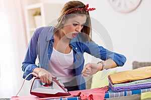 Frustated woman ironing laundry