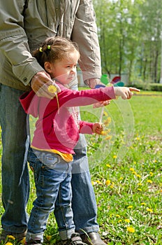 A frustrated 2.5-year-old girl pointing a finger at her offender. The concept of strong emotions, resentment, protection