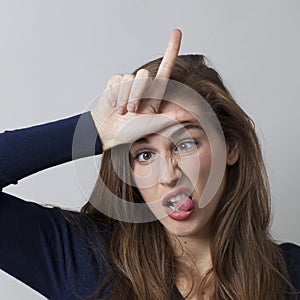 Frustrated 20's woman insulting herself or someone with L loser hand gesture