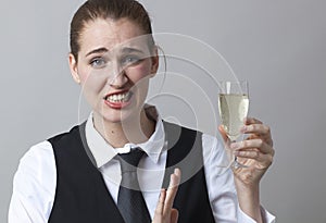 Frustrated 20s girl resisting in drinking more Champagne at party
