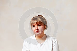 Frustrated 30-year-old girl on  light background