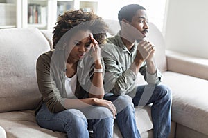 Frustrated african american couple feeling down after fight at home