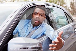 Frustrated African American male driver in car