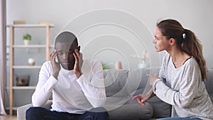 Frustrated african husband tired of annoying angry caucasian wife nagging