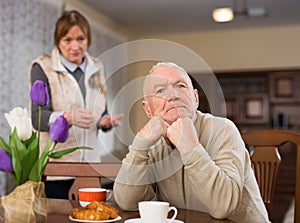 Frustrated aged man with woman rebuking him