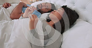 Frustrated, angry and argue couple in bed fight, disagreement and unhappy while talking, shouting or screaming in
