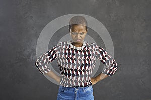 Frustrated, angry, and gloomy African-American woman is unhappy and needs an explanation.