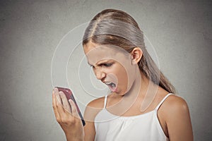 Frustrated angry teenager girl yelling while on phone
