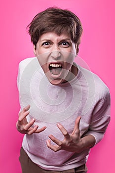 Frustrated and angry woman screaming. Studio shot.