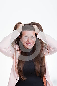 Frustrated annoyed woman tearing hair out