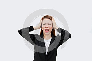 Frustrated Asian business woman screaming and put hands on head with long hair in black suit isolated on white color bakckground