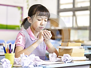 Frustrated asian elementary school girl
