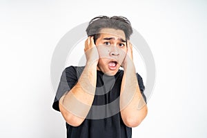 frustrated asian young man cover his ear