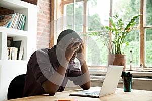 Frustrated black worker disappointed with company crisis