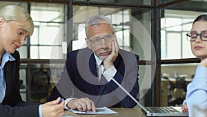 Frustrated boss and unmotivated female workers bored in office, lacking ideas