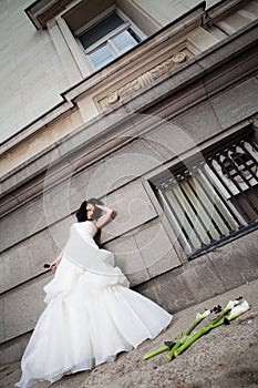 Frustrated bride leaning on wall