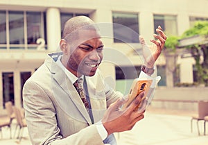 Frustrated business man receiving bad news on mobile phone