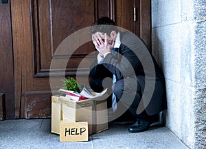 Frustrated business man on street fired carrying cardboard box