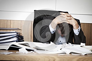 Frustrated business person overloaded with work.