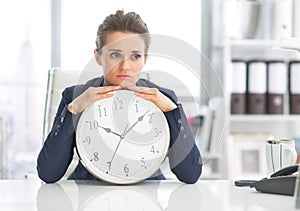 Frustrated business woman with clock