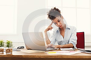 Frustrated business woman with headache at office