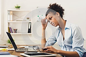 Frustrated business woman with headache at office