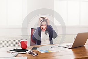 Frustrated business woman with headache at office