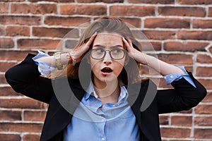 Frustrated business woman holding his hands to her head in frustration.