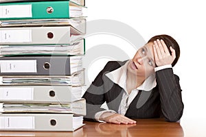 Frustrated business woman looks at folder stack