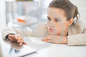 Frustrated business woman working with laptop