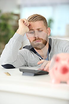 frustrated businessman calculates cost