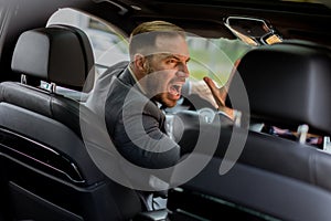 Frustrated businessman caught in traffic during rush hour in the city