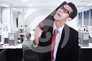 Frustrated businessman cutting his neck