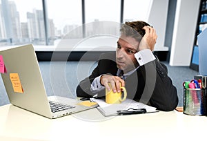 Frustrated businessman desperate face expression suffering stress at office computer desk