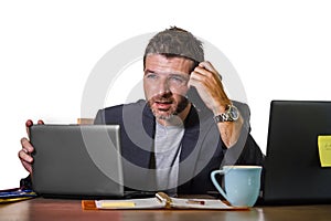 Frustrated businessman desperate at office computer desk holding notepad with the hashtag me too metoo as exploited employee