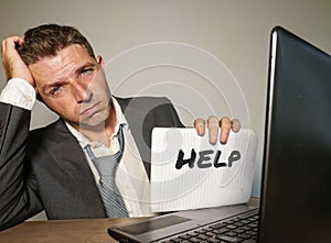 Frustrated businessman desperate at office computer desk holding notepad with the hashtag me too metoo as exploited employee