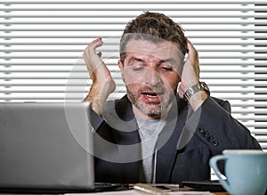 Frustrated businessman desperate at office computer desk holding notepad with the hashtag me too metoo as exploited employee