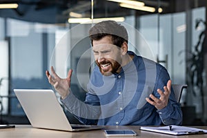 Frustrated businessman experiencing computer problems at work