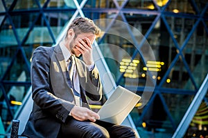 Frustrated businessman on laptop computer