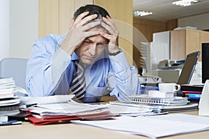 Frustrated Businessman At Office Desk