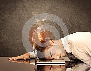 Sad business person`s head catching fire