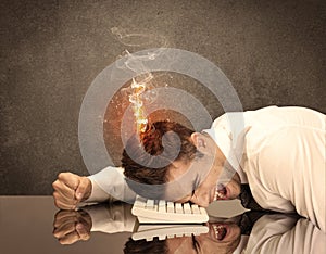 Sad business person`s head catching fire